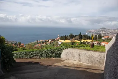 an alley with a white wall and a building at Atlantic View Residence in Funchal