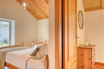 a bedroom with a bed and a window at Ocean View Cottage a Home in Madeira in Fajã da Ovelha
