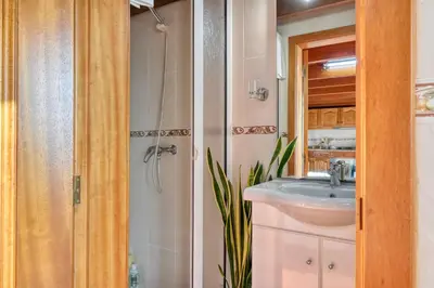a bathroom with a sink and a shower at Ocean View Cottage a Home in Madeira in Fajã da Ovelha