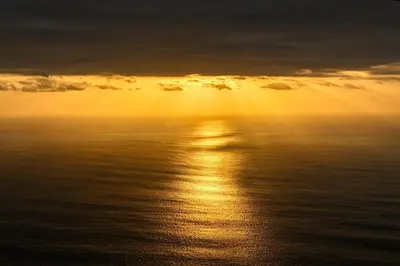 an image of the sun setting over the ocean at Ocean View Cottage a Home in Madeira in Fajã da Ovelha