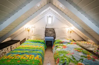 two beds in a room with a attic at Casa Neverland in Vila Baleira