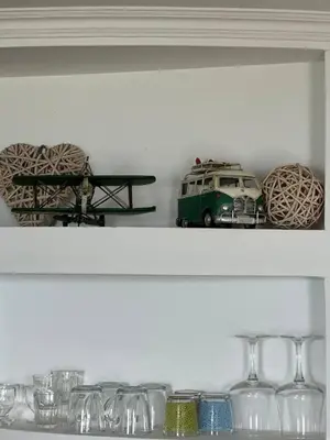 a shelf with a toy van and glasses on it at Taverna in São Jorge