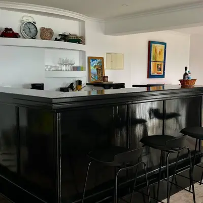 a black bar with stools in a room at Taverna in São Jorge