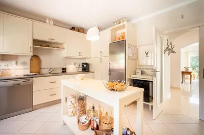 a kitchen with white cabinets and a white counter top at 804 Quinta Felicidade in Lagos