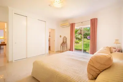 a bedroom with a large bed and a large window at 804 Quinta Felicidade in Lagos