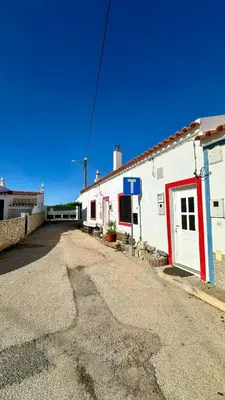 an empty street in front of a white building at Casa do Careca in Sagres
