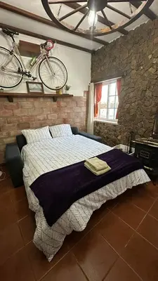 a bedroom with a bed with a bike on the wall at Casa do Careca in Sagres