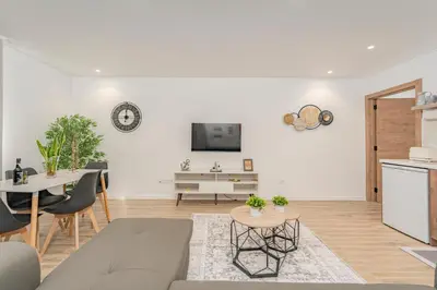 a living room with a couch and a table at Santiago apartment Alpine escape villa in Gaula