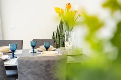 a dining room table with a vase of flowers on it at Panoramic Attic by Sabugo House in Relógio do Poiso