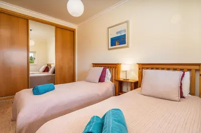 a bedroom with two beds and a mirror at Apt Brightness Comfort In Burgau in Burgau