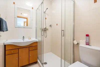 a bathroom with a shower and a sink and a toilet at Apt Brightness Comfort In Burgau in Burgau