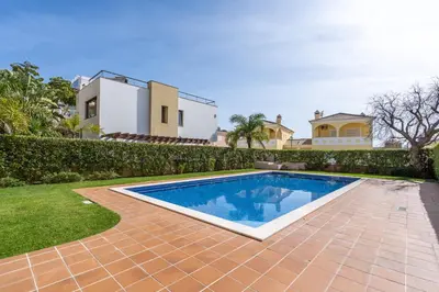 a swimming pool in the yard of a house at Apt Brightness Comfort In Burgau in Burgau