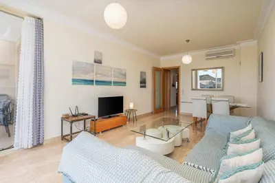 a living room with a couch and a tv at Apt Brightness Comfort In Burgau in Burgau