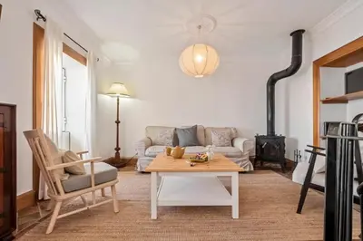a living room with a couch and a table at Ocean View Eiras Cottage II in Fajã da Ovelha