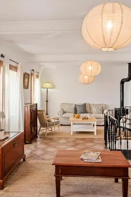 a living room with a couch and a table at Ocean View Eiras Cottage II in Fajã da Ovelha