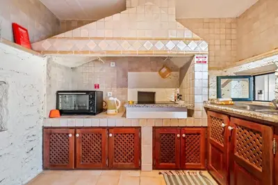 a kitchen with a counter top with a microwave at Ocean View Eiras Cottage II in Fajã da Ovelha