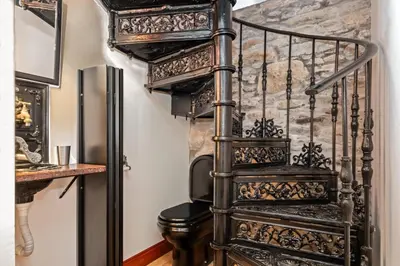 a spiral staircase in a room with a refrigerator at Ocean View Eiras Cottage II in Fajã da Ovelha