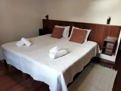 a bedroom with a large bed with towels on it at Hortasol B in Funchal