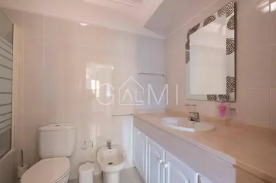 a bathroom with a toilet and a sink and a mirror at Casa do Pico by GALMI in Funchal