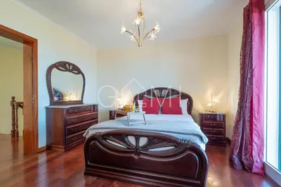 a bedroom with a large bed and a mirror at Casa do Pico by GALMI in Funchal