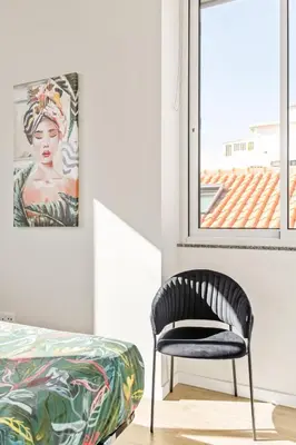 a living room with a couch and a tv at Sé Cathedral Roof House in Funchal