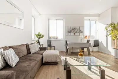 a living room with a dining table and a television at Sé Cathedral Roof House in Funchal