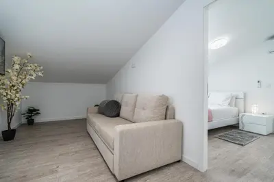 a living room with a couch and a bed at Ana's View, cozy apartment, AC, sea view & parking in Arco da Calheta