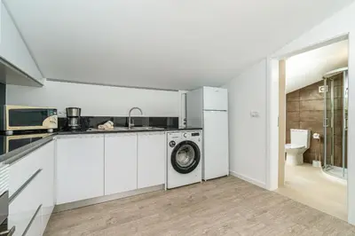 a kitchen with a washing machine and a sink at Ana's View, cozy apartment, AC, sea view & parking in Arco da Calheta