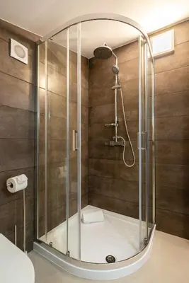a shower with a glass door in a bathroom at Ana's View, cozy apartment, AC, sea view & parking in Arco da Calheta