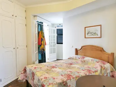 a bedroom with a bed and a table at NewCastle in Funchal
