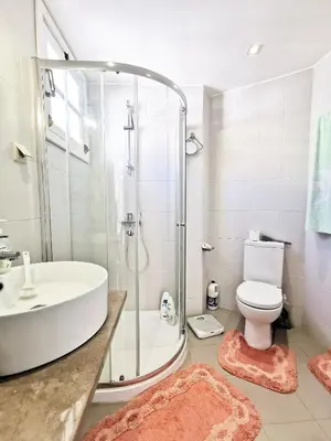 a bathroom with a shower and a toilet and a sink at NewCastle in Funchal