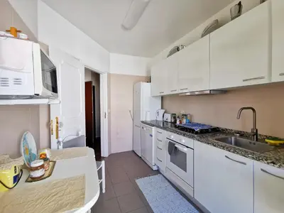 a kitchen with white cabinets and a sink at NewCastle in Funchal