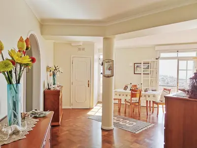 a living room with a table and a dining room at NewCastle in Funchal