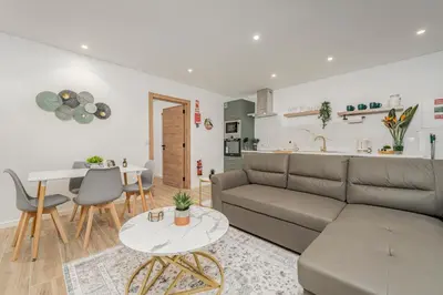a living room with a couch and a table at Vienna apartment Alpine escape villa in Gaula