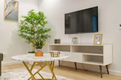 a living room with a tv and a coffee table at Vienna apartment Alpine escape villa in Gaula