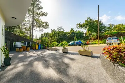 a parking lot with potted plants and parked cars at Vienna apartment Alpine escape villa in Gaula