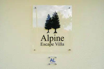 a sign on a wall with a tree on it at Vienna apartment Alpine escape villa in Gaula