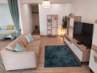 a living room with a couch and a flat screen tv at Apartment Studio Espiche near Praia da Luz in Luz