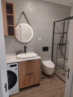 a bathroom with a sink and a washing machine at Apartment Studio Espiche near Praia da Luz in Luz