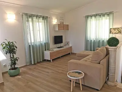 a living room with a couch and a tv at Apartment Studio Espiche near Praia da Luz in Luz