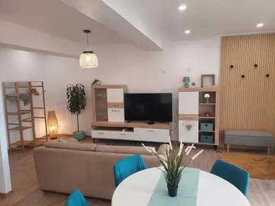 a living room with a couch and a tv at Apartment Studio Espiche near Praia da Luz in Luz