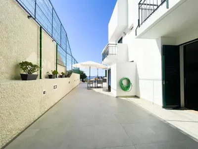 an empty hallway of a building with a green circle on it at Flor do Lido in Funchal