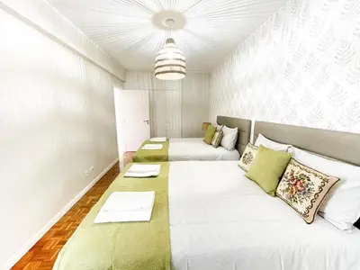 a living room with two beds and a couch at Flor do Lido in Funchal