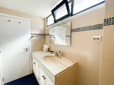 a bathroom with a sink and a mirror at Flor do Lido in Funchal
