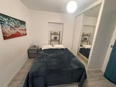 a bedroom with a large bed and a mirror at LOV - Lombadinha Ocean View in Gaula
