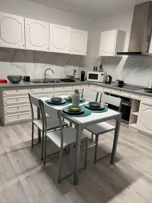 a kitchen with a table and chairs in it at LOV - Lombadinha Ocean View in Gaula