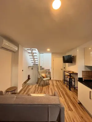 a living room with a couch and a table at Private 1 bedroom house in Machico Centre in Machico