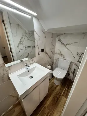 a white bathroom with a sink and a toilet at Private 1 bedroom house in Machico Centre in Machico