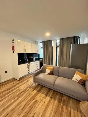 a living room with a couch and a kitchen at Private 1 bedroom house in Machico Centre in Machico