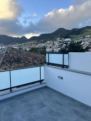 a balcony with a view of a city at Private 1 bedroom house in Machico Centre in Machico